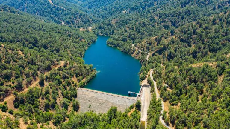 Arminou dam water reservoir in Troodos Mountains, Paphos forest, Cyprus. Aerial view of the earthfill dam, artificial lake